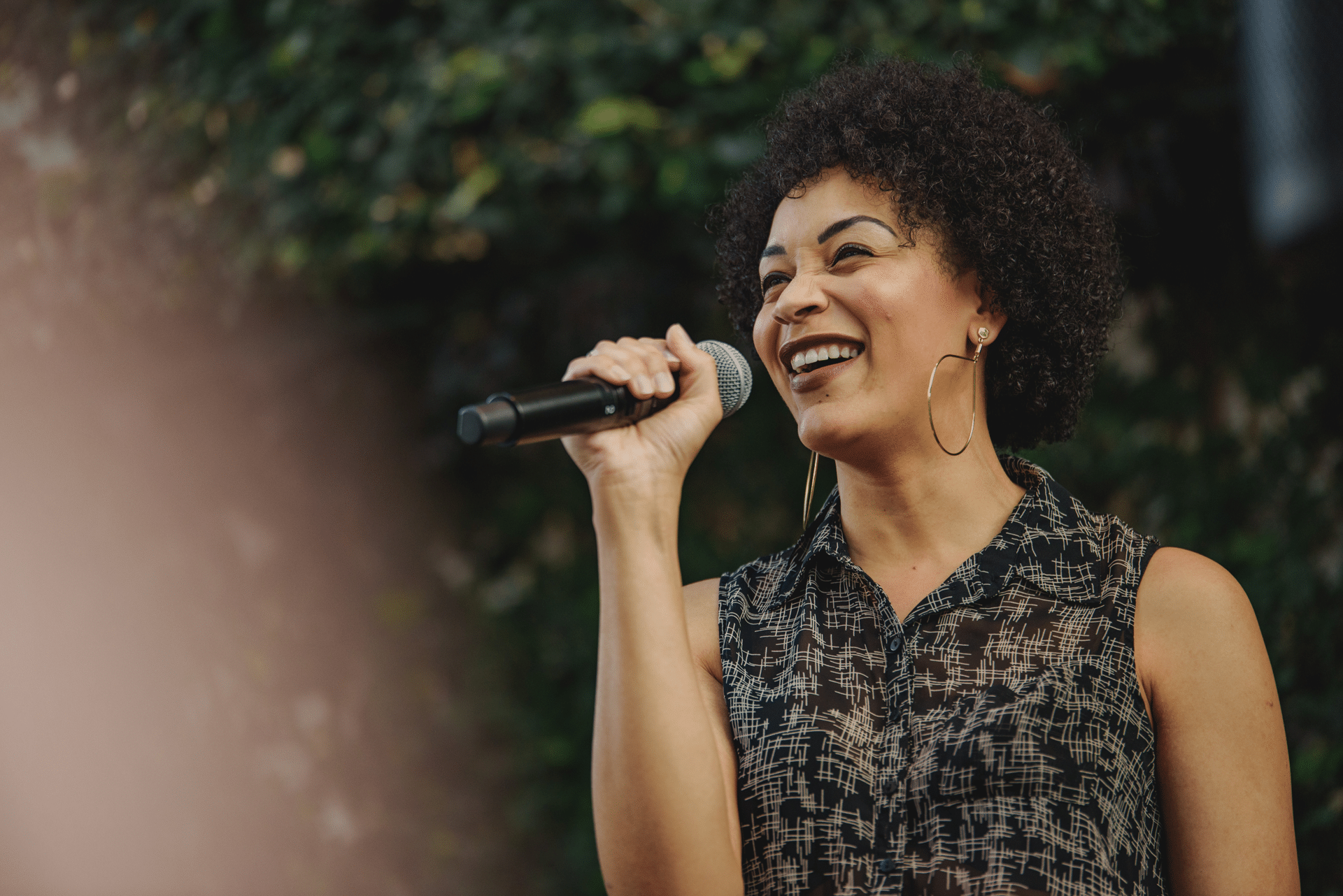 Woman smiling holding microphone