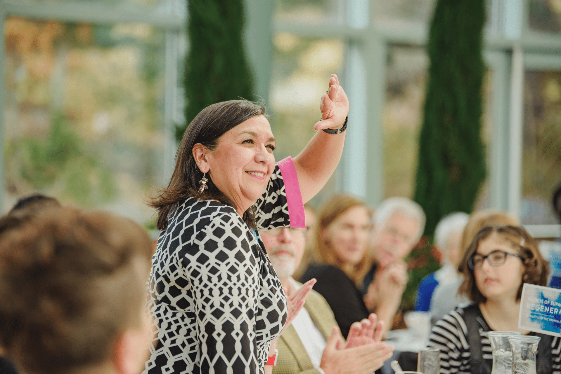 Woman waving and smiling