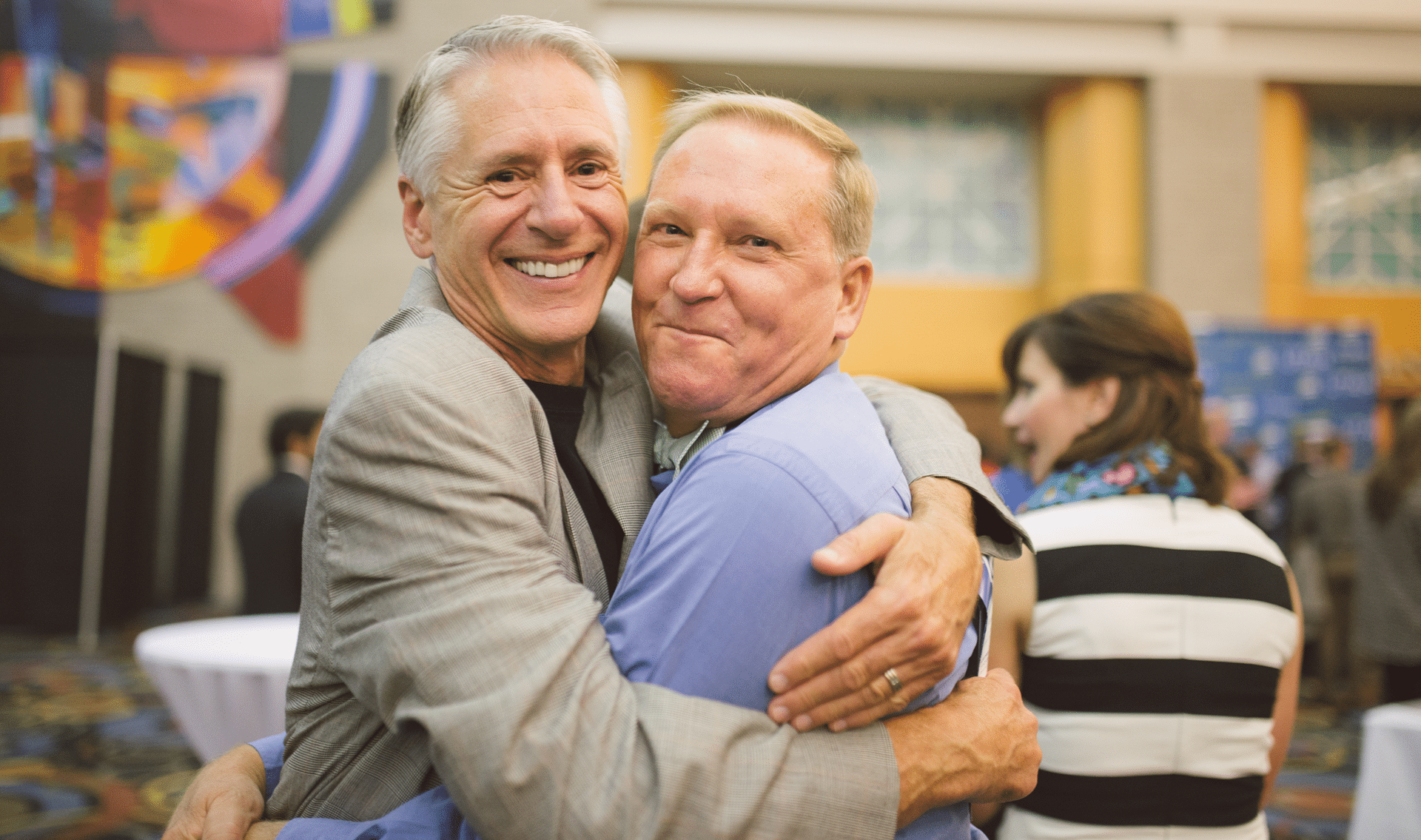 Two smiling men hugging