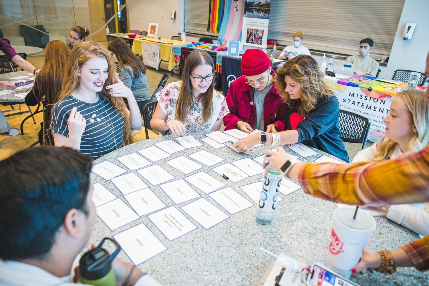 Group of students sitting around a table looking at flash cards