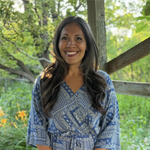 Headshot of Stacy Bernal outside in casual attire.