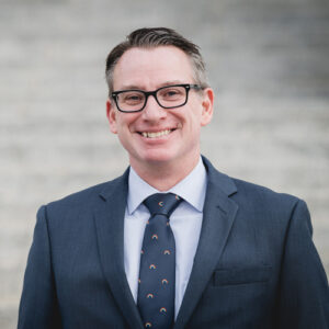 Headshot of Travis Smith in formal attire.