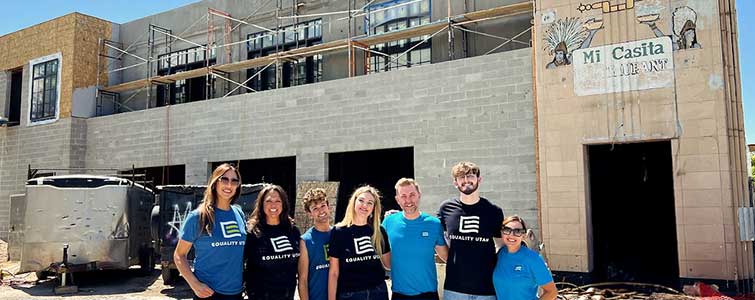 Equality Utah team posed outside of a building under construction