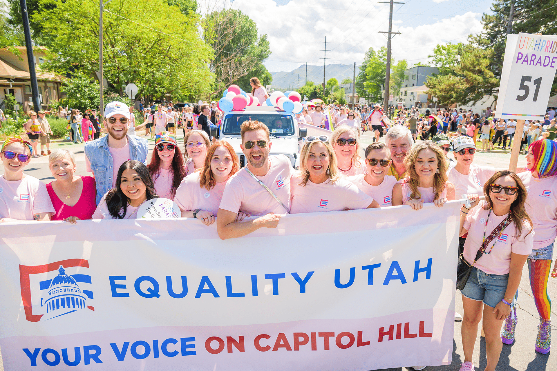 Groups holding large sign: Equality Utah, Your voice on capitol hill